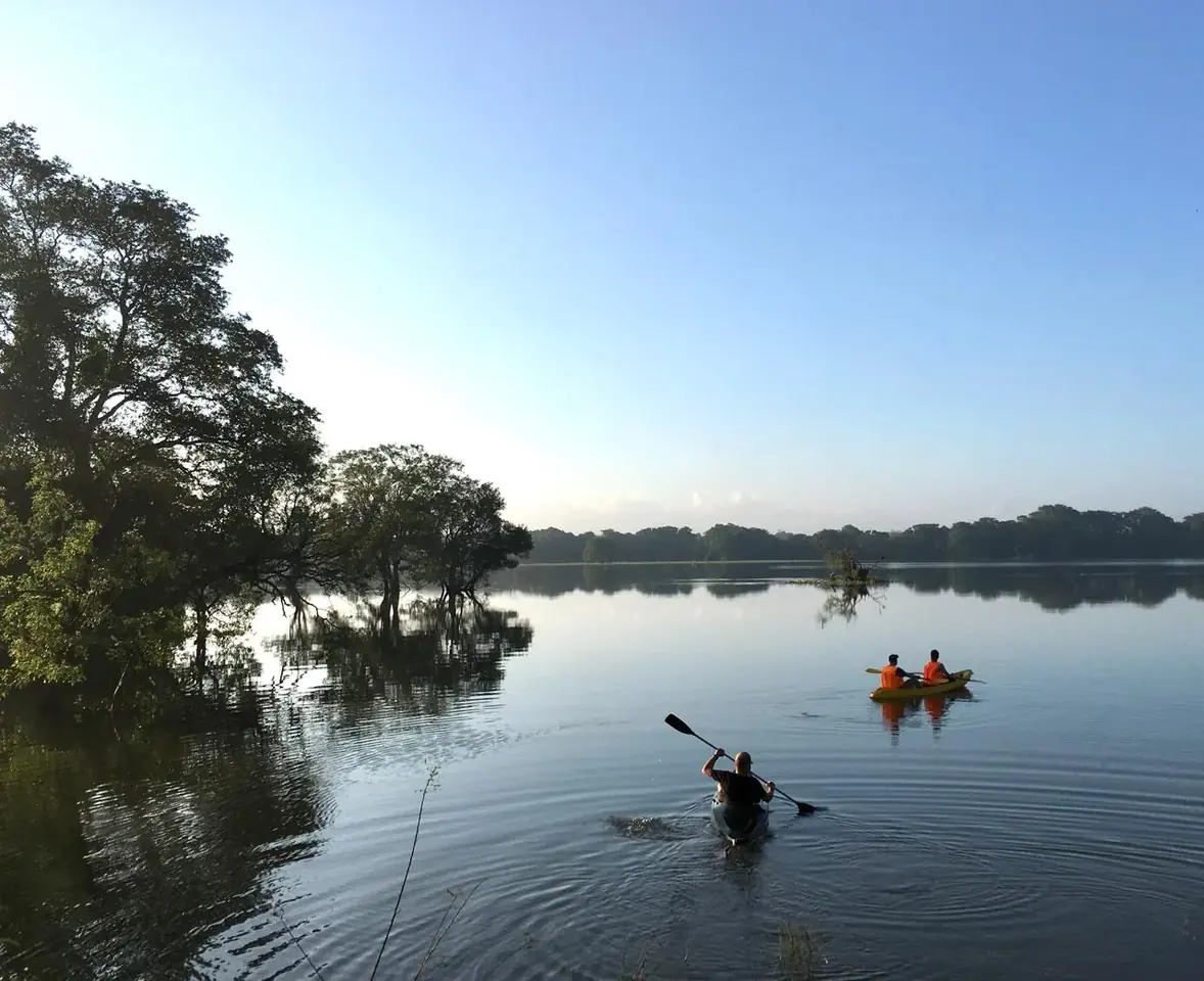 Guests kayaking on the Galkadawala village lake at first light