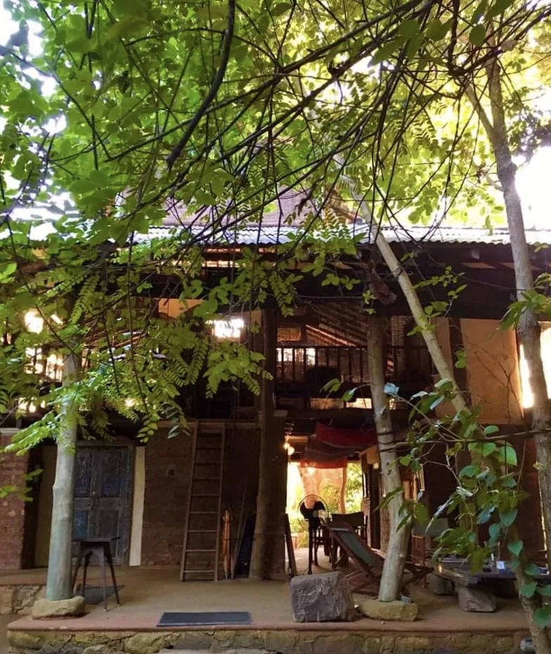 The first bungalow seen from the garden, with its ladder and deck among the trees