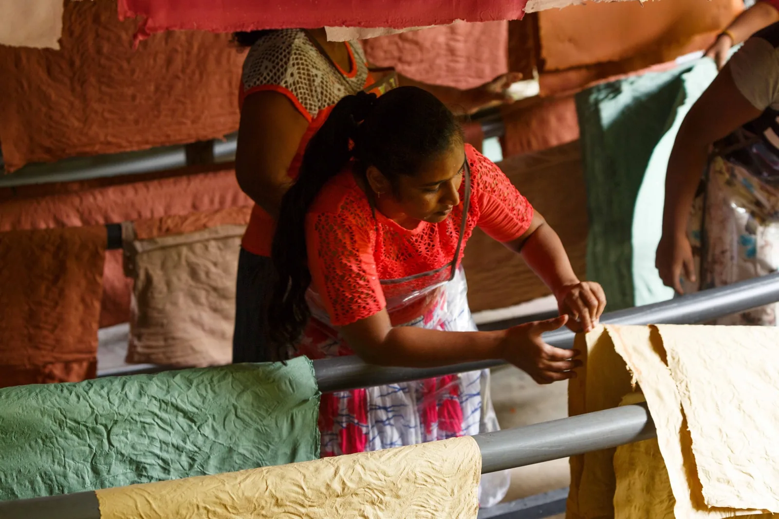 Lifting a fresh sheet of handmade paper