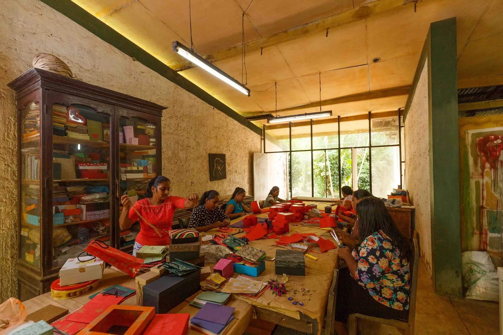 Women of the village making boxes and gift bags from handmade paper in the Kadadasi workshop